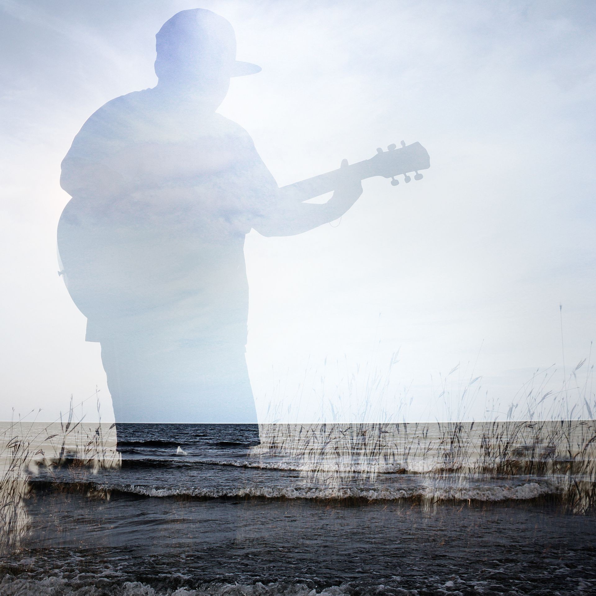 Man playing acoustic guitar and double exposure sky background.